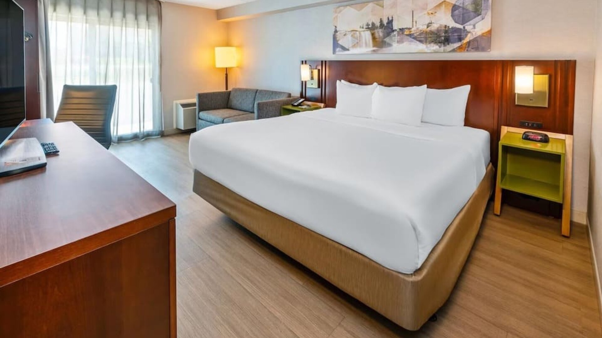 King guest room featuring a comfortable king bed, seating area, work desk, and modern amenities at Comfort Inn Sudbury Regent Street.