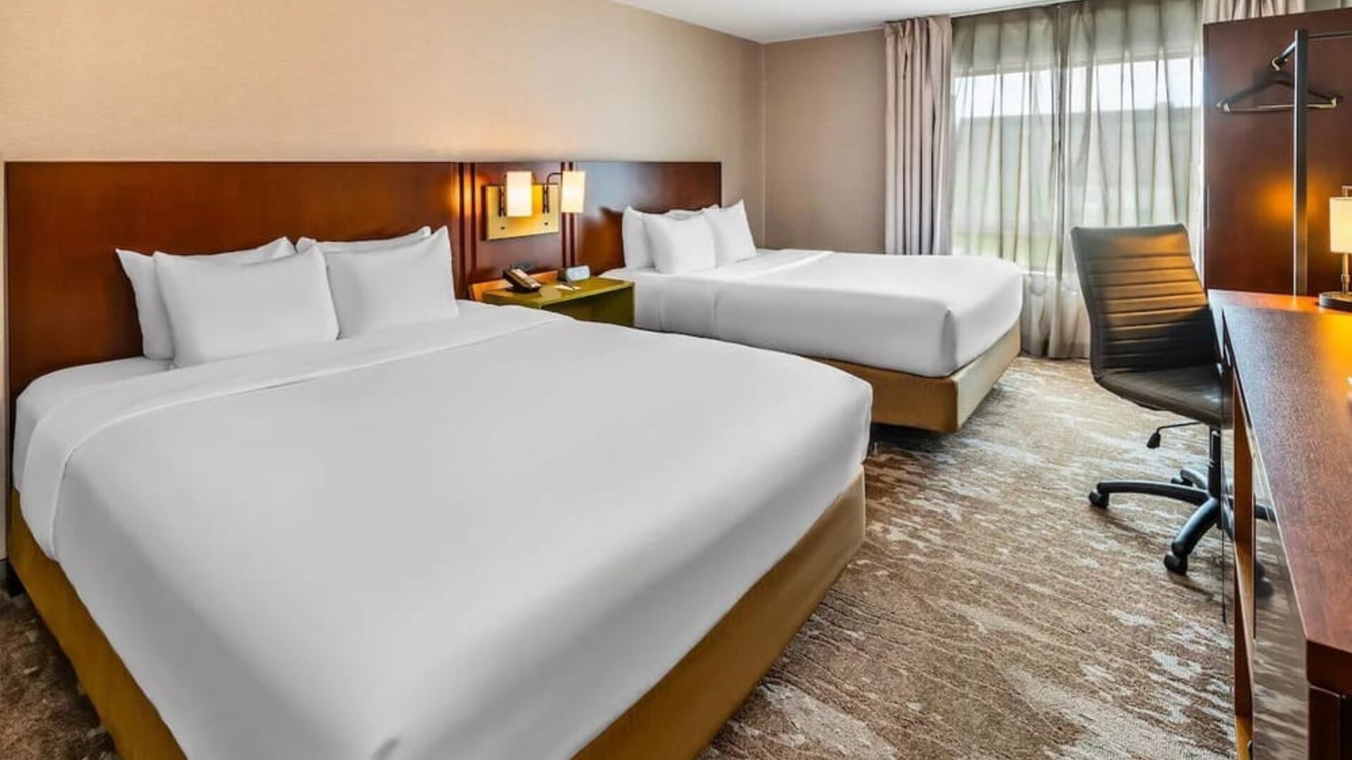 Guest room featuring two comfortable queen beds, a work desk, HDTV, and modern amenities at Comfort Inn Sudbury Regent Street.