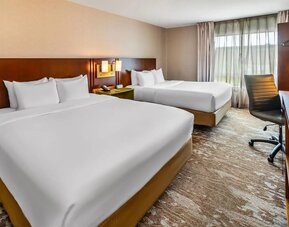 Guest room featuring two comfortable queen beds, a work desk, HDTV, and modern amenities at Comfort Inn Sudbury Regent Street.