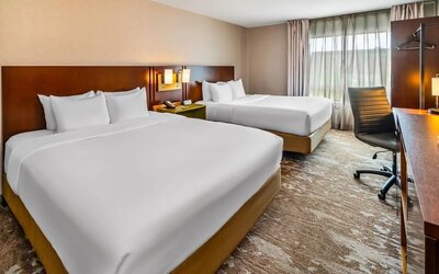 Guest room featuring two comfortable queen beds, a work desk, HDTV, and modern amenities at Comfort Inn Sudbury Regent Street.