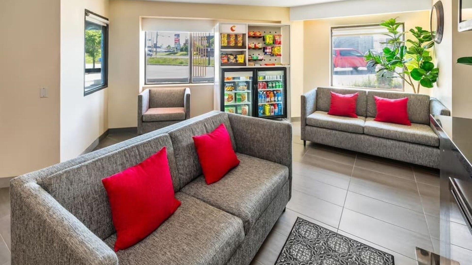 Comfortable lobby seating area with a fireplace, snack market, and easy access to the breakfast area at Comfort Inn Sudbury Regent Street.