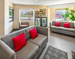 Comfortable lobby seating area with a fireplace, snack market, and easy access to the breakfast area at Comfort Inn Sudbury Regent Street.