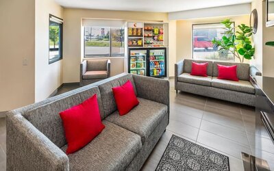 Comfortable lobby seating area with a fireplace, snack market, and easy access to the breakfast area at Comfort Inn Sudbury Regent Street.