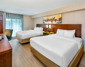 Guest room with two queen beds, hardwood flooring, workspace, and modern décor at Comfort Inn Sudbury East.