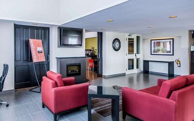 Lobby lounge featuring comfortable seating, fireplace, and access to the breakfast area at Comfort Inn Sudbury East.