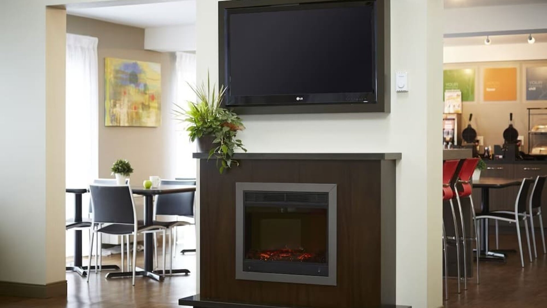 Inviting lobby featuring a fireplace, seating area, and breakfast space at Comfort Inn Sudbury East.