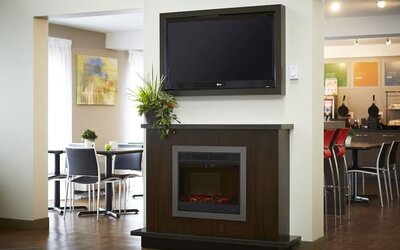 Inviting lobby featuring a fireplace, seating area, and breakfast space at Comfort Inn Sudbury East.