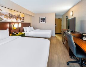 Guest room with two queen beds, workspace, and contemporary amenities at Comfort Inn Sudbury East.