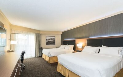Guest room with two queen beds, workspace, and contemporary furnishings at Holiday Inn Express Edmonton Downtown, an IHG Hotel.