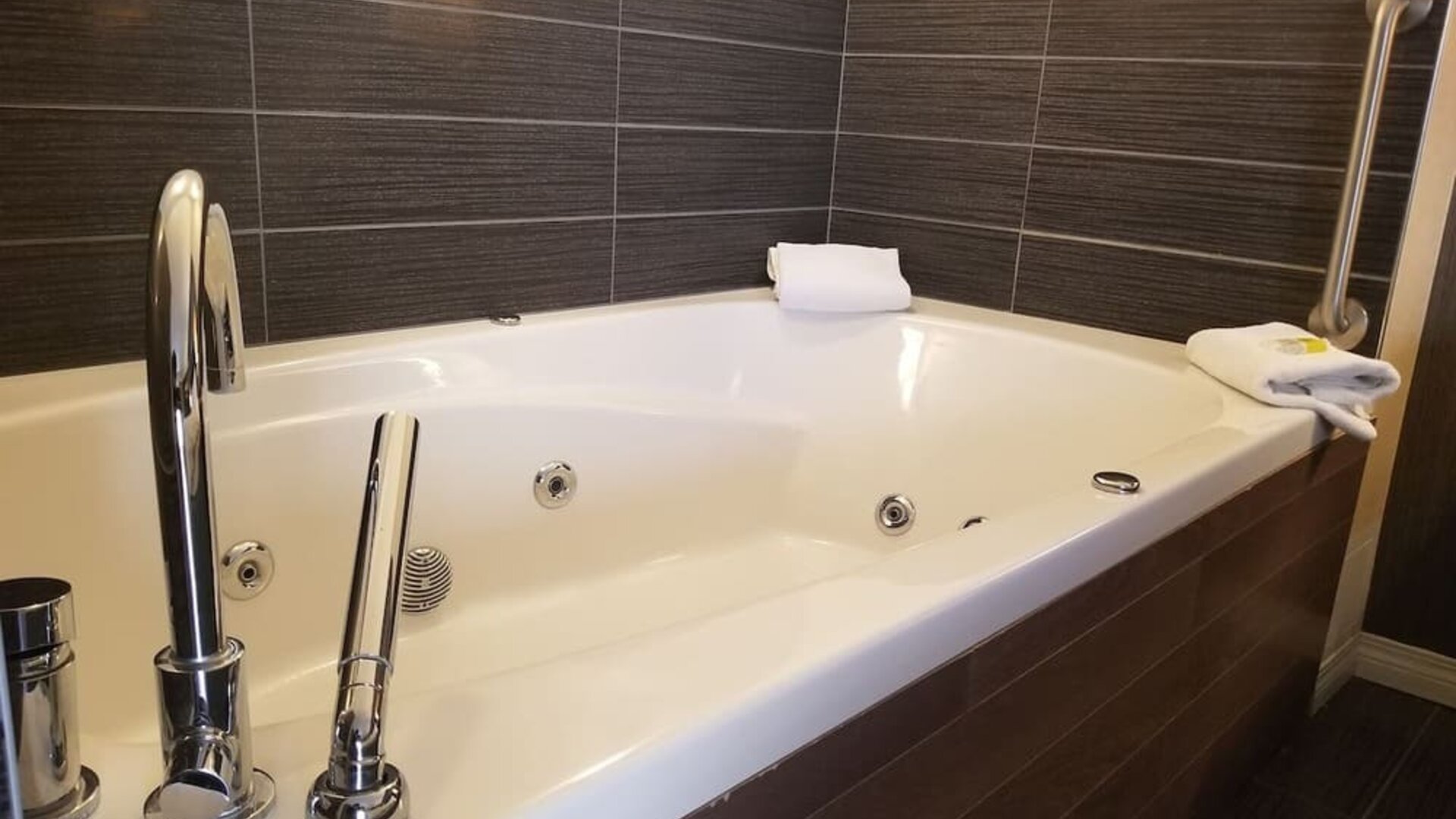 Guest bathroom with a jetted soaking tub at Holiday Inn Express Edmonton Downtown, an IHG Hotel.