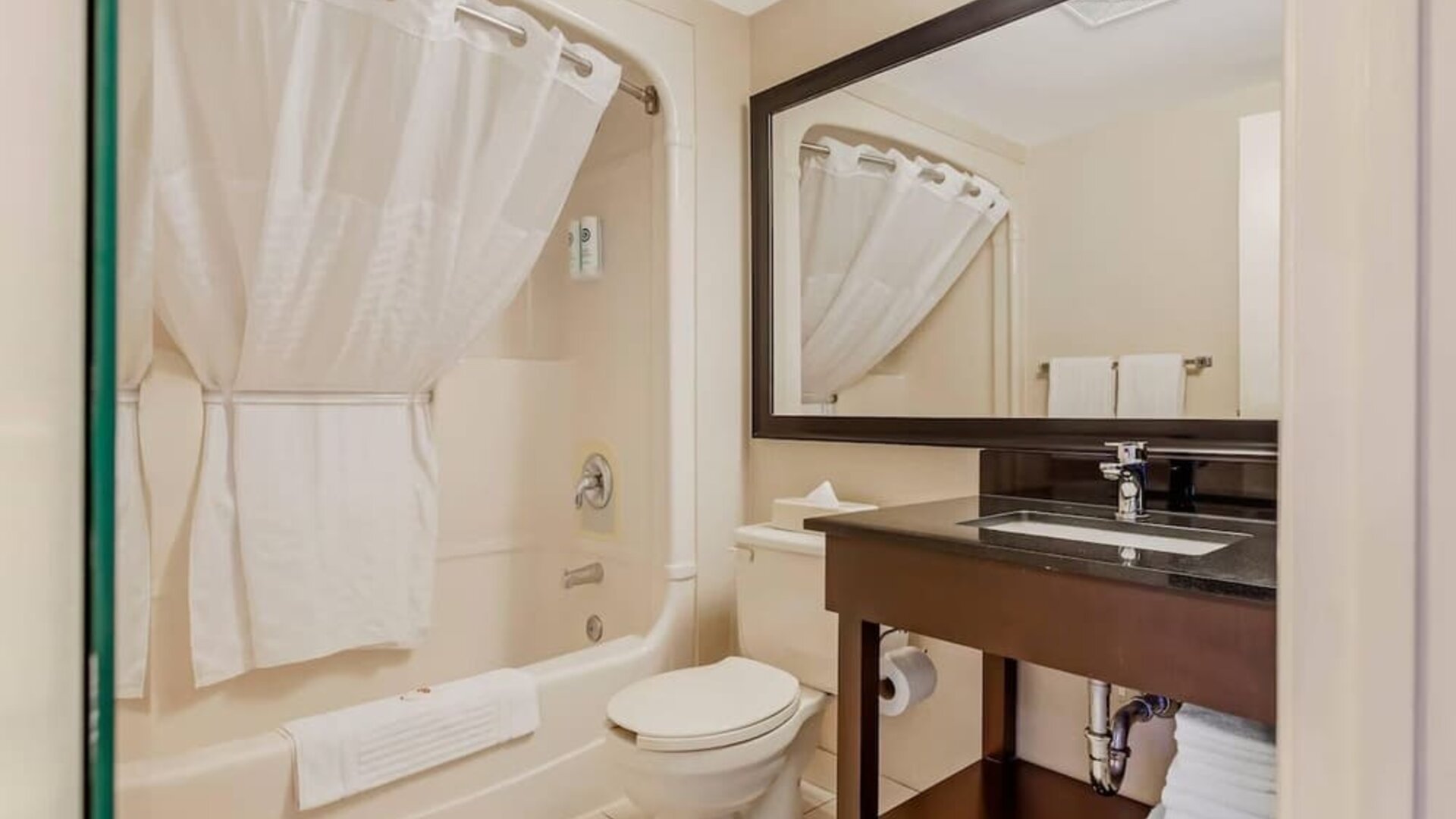 Guest bathroom with a shower and granite vanity at Comfort Inn Brantford.