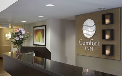Reception desk with Comfort Inn signage at Comfort Inn Sept-Iles.