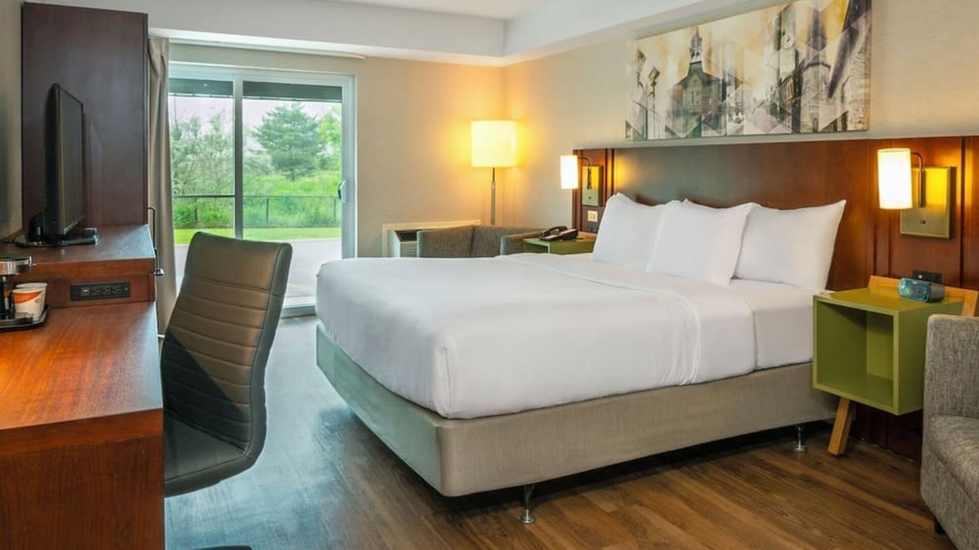 Spacious king guest room with a sofa and work desk at Comfort Inn Sault Ste. Marie.