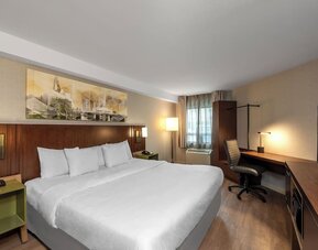King guest room with a work desk and wardrobe at Comfort Inn Sault Ste. Marie.
