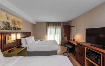 Guest room with two queen beds and a work desk at Comfort Inn Sault Ste. Marie.