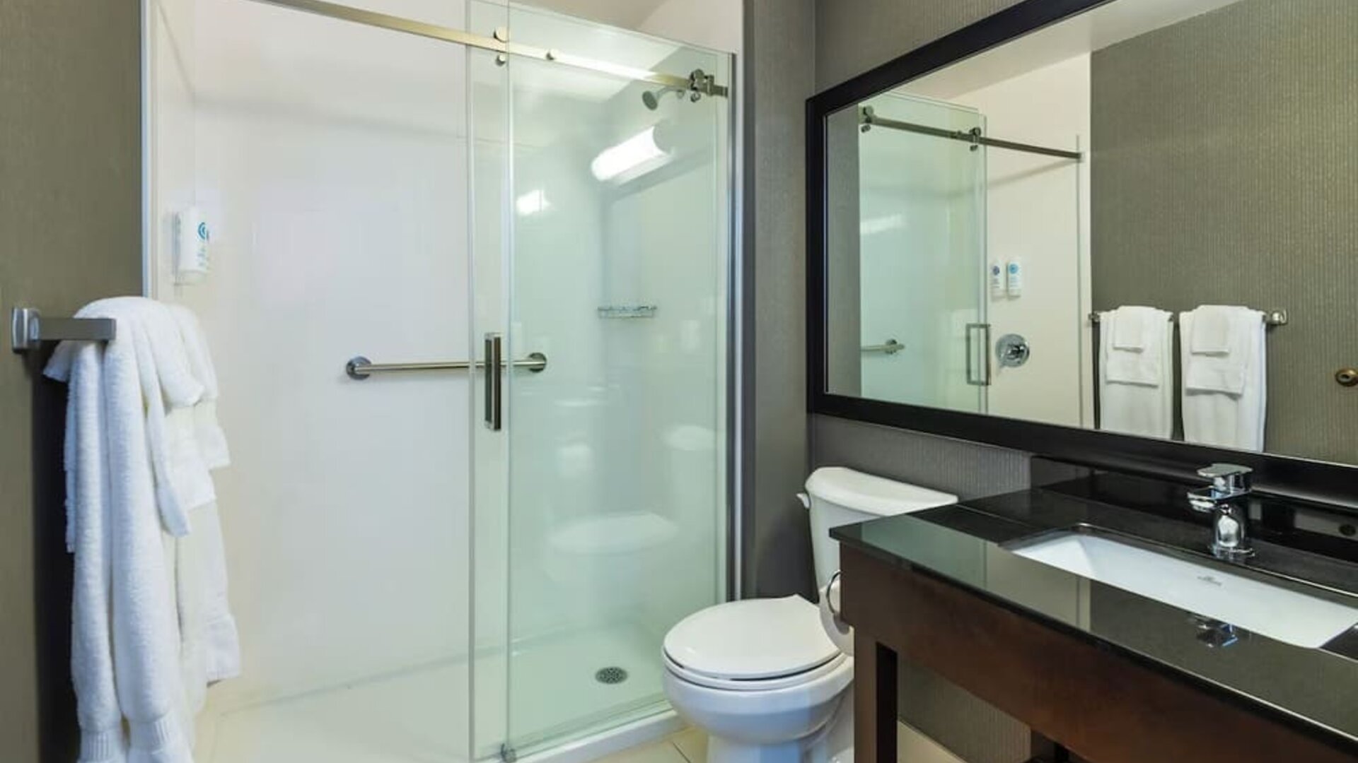 Guest bathroom with a walk-in shower and vanity at Comfort Inn Sault Ste. Marie.