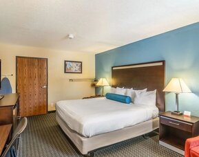 Spacious guest room with a king bed and work desk at Glenridge Inn Glendale Pasadena.