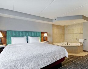 Guest room with a king bed and in-room whirlpool tub at Hampton Inn & Suites By Hilton Guelph.