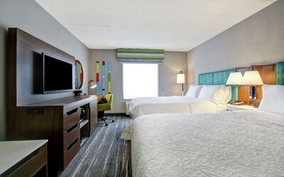 Guest room with two queen beds and modern furnishings at Hampton Inn & Suites By Hilton Guelph.