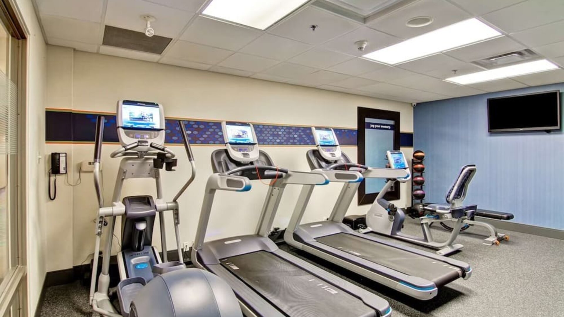 Fitness center with cardio equipment and free weights at Hampton Inn & Suites By Hilton Guelph.