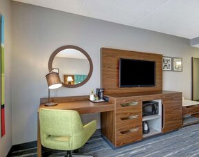 In-room workspace with a TV, microwave, mini fridge, and coffee station at Hampton Inn & Suites By Hilton Guelph.