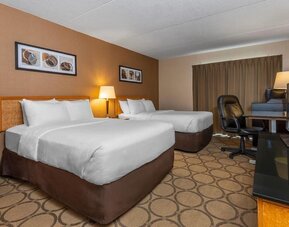 Guest room with two queen beds and a work desk at Comfort Inn Brandon.