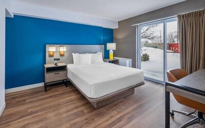 Guest room with a king bed and patio access at Comfort Inn Belleville.