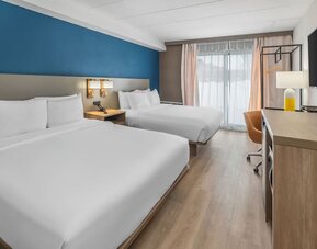 Guest room with two queen beds and modern furnishings at Comfort Inn Belleville.