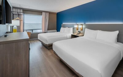 Guest room with two queen beds and large window at Comfort Inn Belleville.