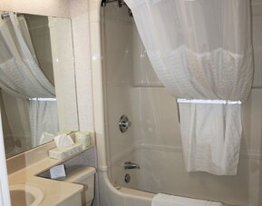 Guest bathroom with a bathtub and shower combination at Comfort Inn Swift Current.