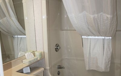 Guest bathroom with a bathtub and shower combination at Comfort Inn Swift Current.