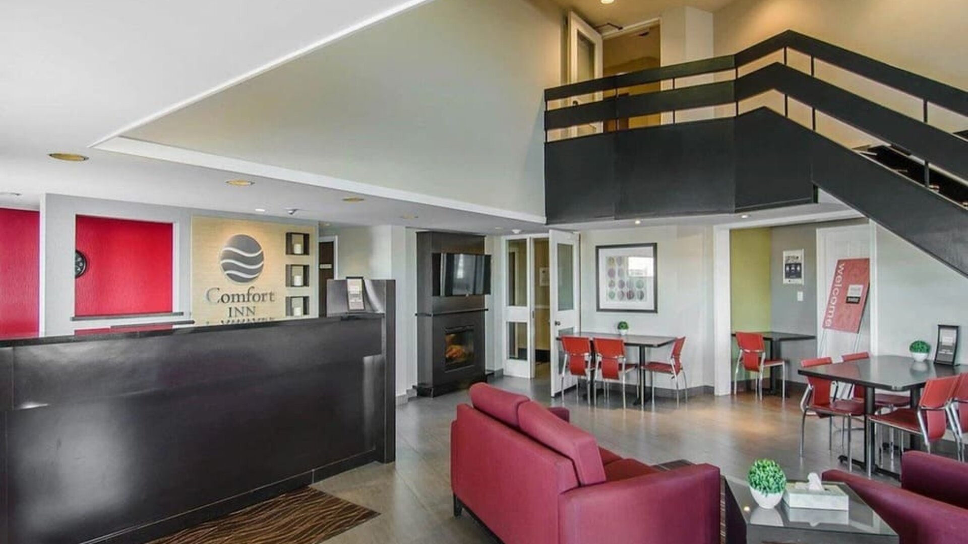 Hotel lobby with seating area and reception desk at Comfort Inn Swift Current.