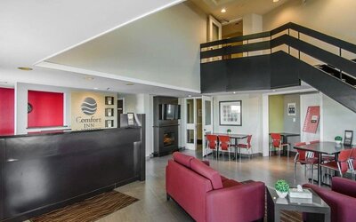 Hotel lobby with seating area and reception desk at Comfort Inn Swift Current.