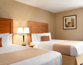 Guest room with two double beds and bedside lighting at Days Inn Edmonton Downtown.