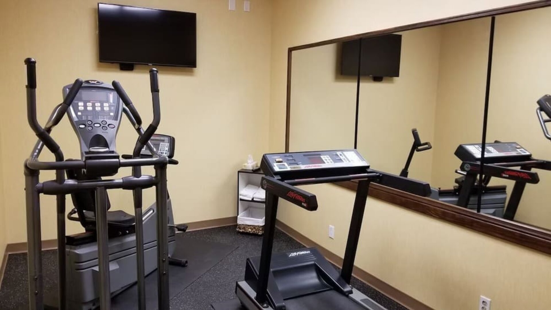 Fitness center with a treadmill and elliptical machine at Days Inn Edmonton Downtown.