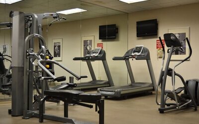 Fitness center with cardio and strength-training equipment at Amenida Residences.