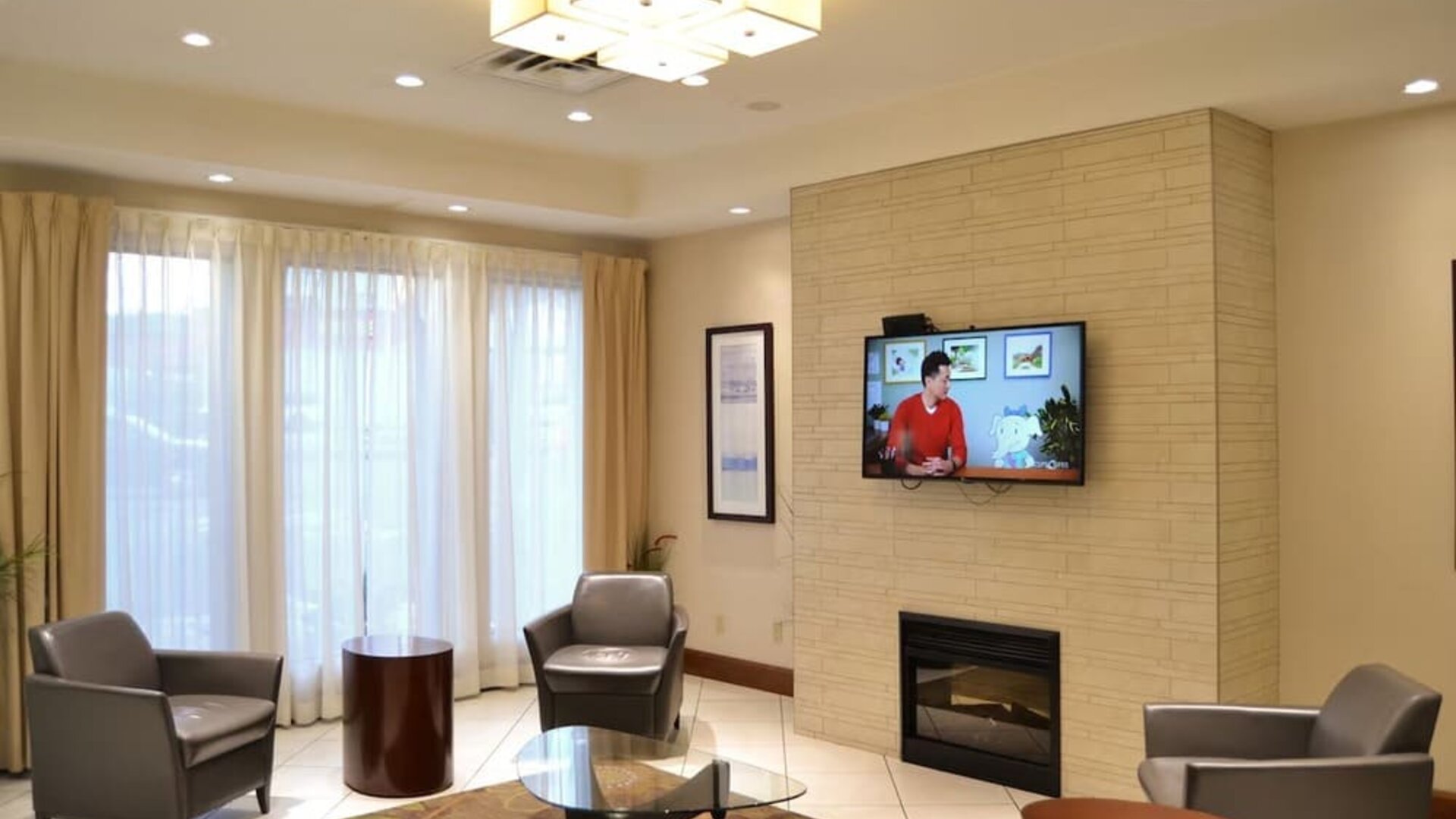 Hotel lobby with fireplace and comfortable seating at Amenida Residences.
