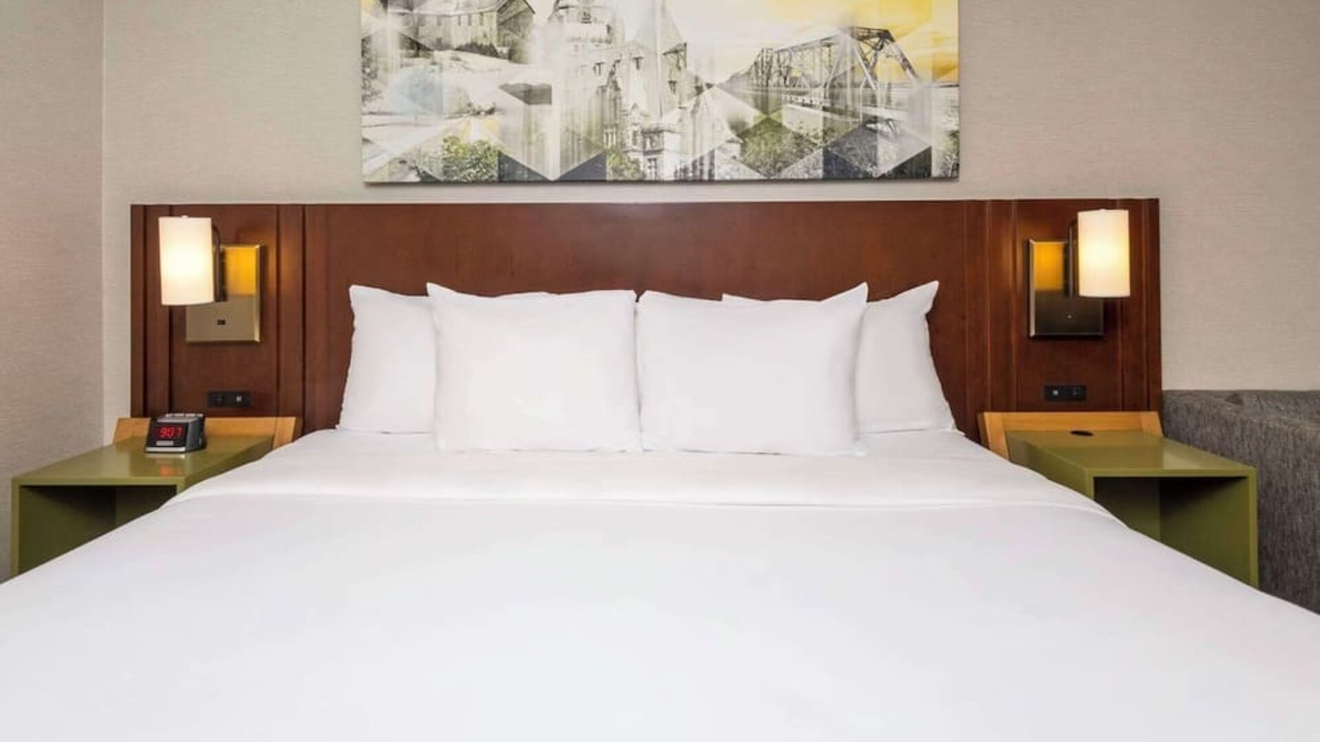 King bed with upholstered headboard and bedside lighting at Comfort Inn Brossard.