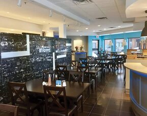 Hotel dining area with tables and breakfast buffet at Comfort Inn Edmonton West.