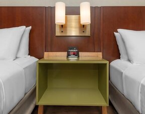 Nightstand between two beds with bedside lighting at Comfort Inn Ottawa East.
