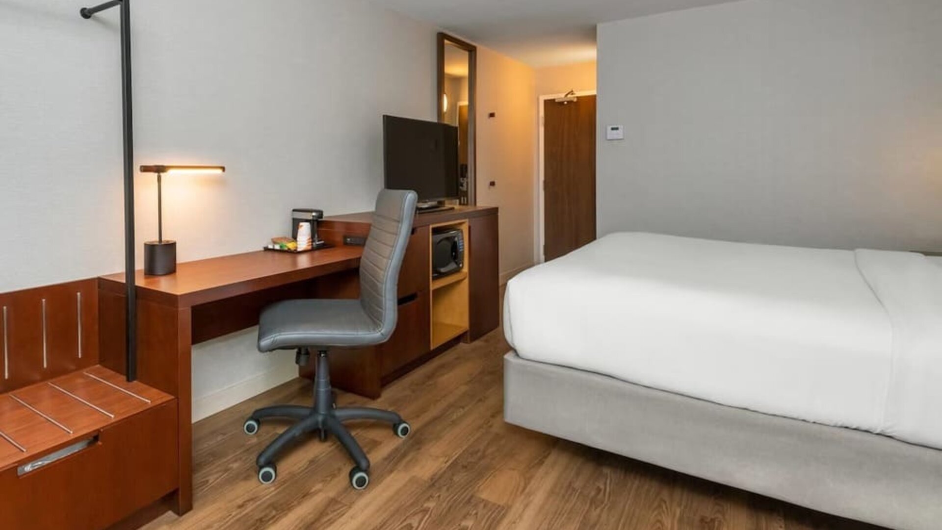 Guest room with a king bed, work desk, and microwave at Comfort Inn Ottawa East.
