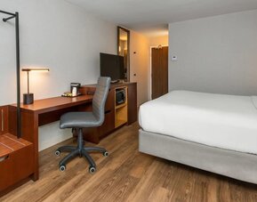 Guest room with a king bed, work desk, and microwave at Comfort Inn Ottawa East.