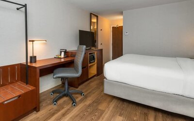 Guest room with a king bed, work desk, and microwave at Comfort Inn Ottawa East.