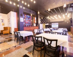 Hotel restaurant with indoor dining tables and ambient lighting at Sherry Frontenac Oceanfront Hotel.