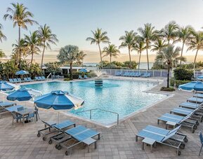 Outdoor swimming pool with sun loungers and ocean views at Sherry Frontenac Oceanfront Hotel.