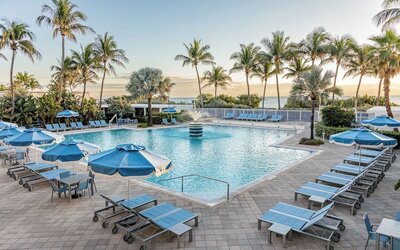 Outdoor swimming pool with sun loungers and ocean views at Sherry Frontenac Oceanfront Hotel.