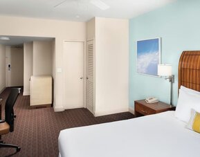 Guest room with a king bed and work desk at Sherry Frontenac Oceanfront Hotel.