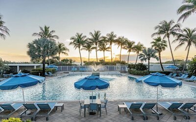Outdoor swimming pool with lounge chairs and ocean views at Sherry Frontenac Oceanfront Hotel.