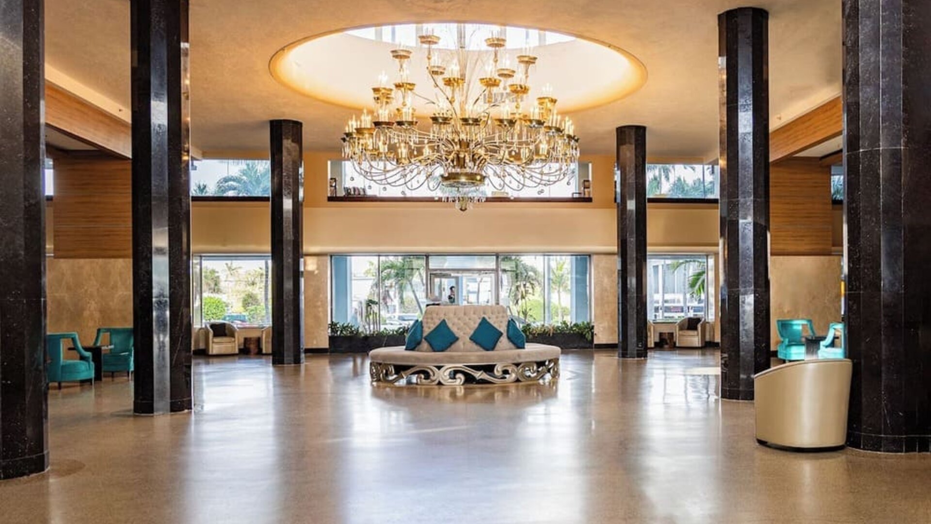 Grand hotel lobby with chandelier and lounge seating at Sherry Frontenac Oceanfront Hotel.