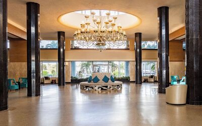 Grand hotel lobby with chandelier and lounge seating at Sherry Frontenac Oceanfront Hotel.